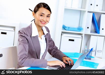 Young pretty woman in business wear working in office