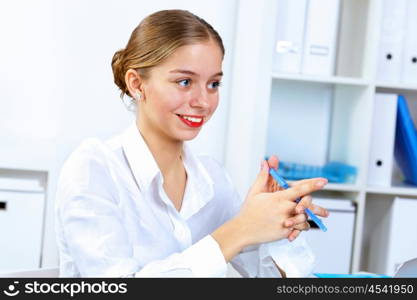 Young pretty woman in business wear working in office