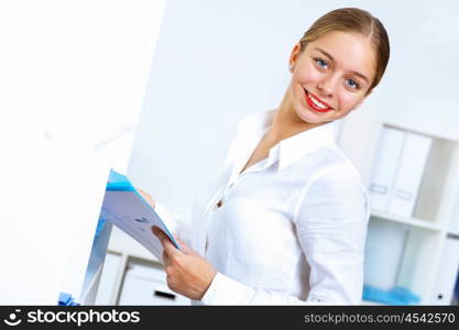 Young pretty woman in business wear working in office