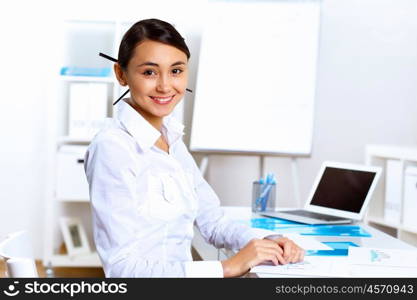 Young pretty woman in business wear working in office