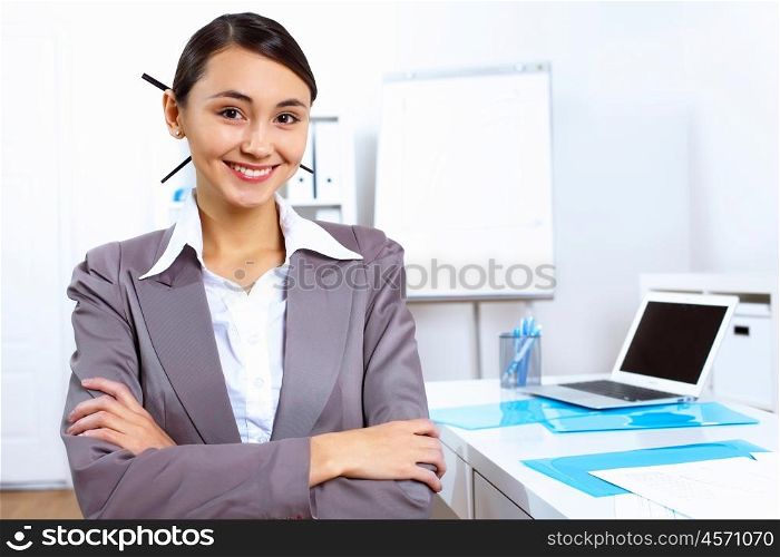 Young pretty woman in business wear working in office