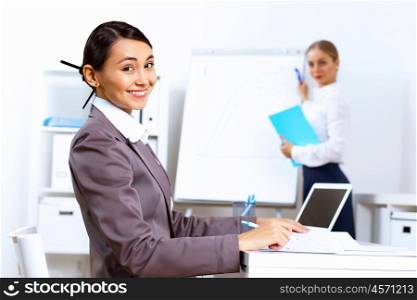 Young pretty woman in business wear working in office