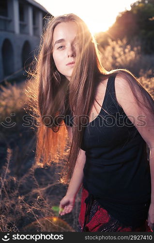 Young Pretty Woman In The Autumn Park at Sunset. Backlit.