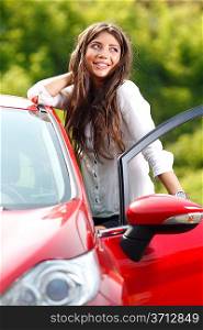 Young pretty woman in the red car