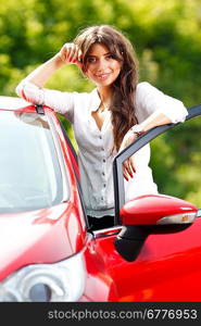 Young pretty woman in the red car