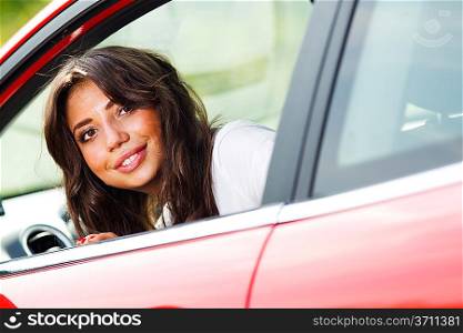 Young pretty woman looking at back of car