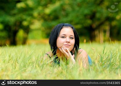 Young pretty woman lying on meadow