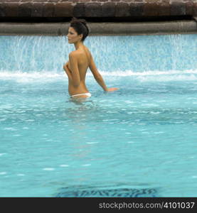 Young pretty woman relaxing in a swimming pool