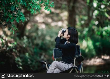 Young pretty woman use digital camera taking a photo beautiful nature while c&ing in forest with happiness, copy space