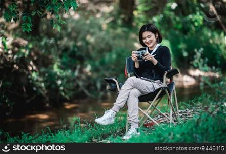 Young pretty woman use digital camera taking a photo beautiful nature while c&ing in forest with happiness, copy space