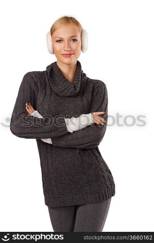 young pretty woman wearing white earmuffs and gray wool sweater be ready to go out in a cold winter day standing and looking at the camera against white background