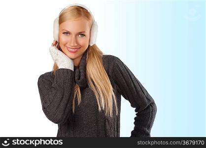 young pretty woman wearing white earmuffs and gray wool sweater be ready to go out in a cold winter day against white background