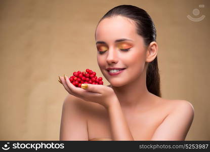 Young pretty woman with berries in beauty concept