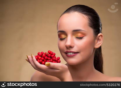 Young pretty woman with berries in beauty concept