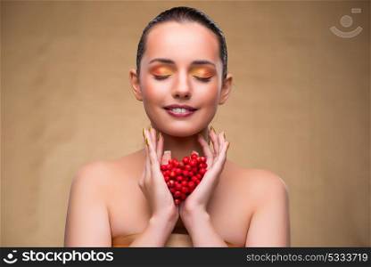 Young pretty woman with berries in beauty concept