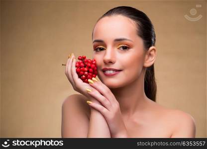 Young pretty woman with berries in beauty concept