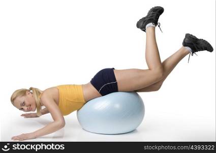 young pretty woman with gym body , doing fitness exercise with ball isolated on white