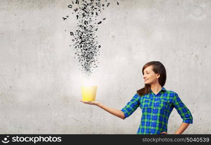 Young pretty woman with yellow bucket in hands