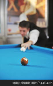 young pro billiard player finding best solution and right angle at billard or snooker pool sport game