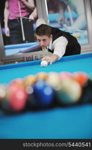 young pro billiard player finding best solution and right angle at billard or snooker pool sport game