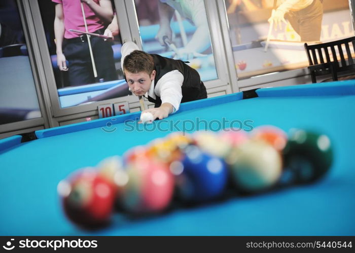 young pro billiard player finding best solution and right angle at billard or snooker pool sport game