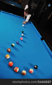 young pro billiard player finding best solution and right angle at billard or snooker pool sport game