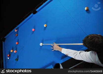 young pro billiard player finding best solution and right angle at billard or snooker pool sport game