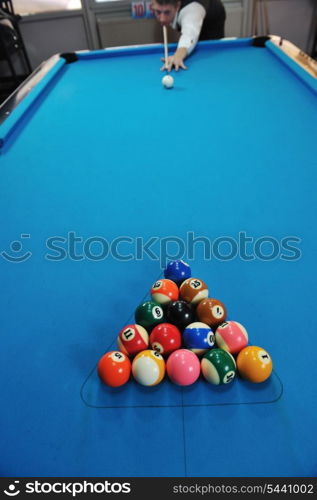 young pro billiard player finding best solution and right angle at billard or snooker pool sport game