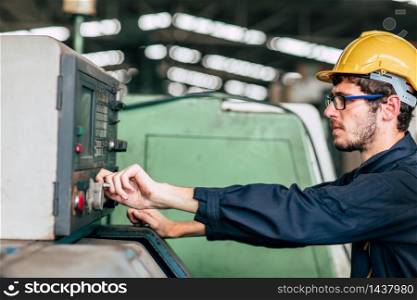 young profession technician engineer operate heavy machine to automated CNC in factory, close-up worker hand.