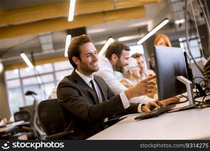 Young professional businessman uses a laptop for work in the modern office