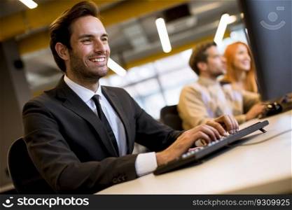 Young professional businessman uses a laptop for work in the office