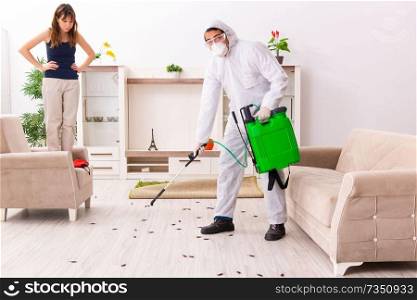 Young professional contractor doing pest control at flat