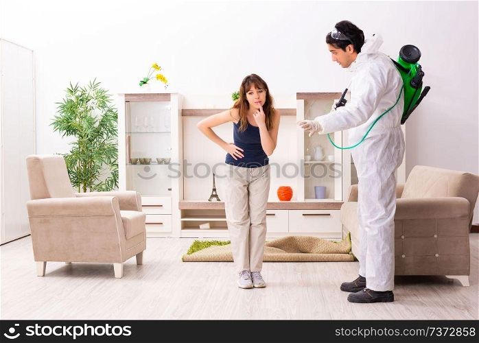 Young professional contractor doing pest control at flat 