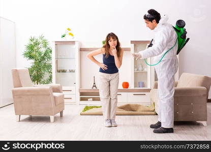 Young professional contractor doing pest control at flat 