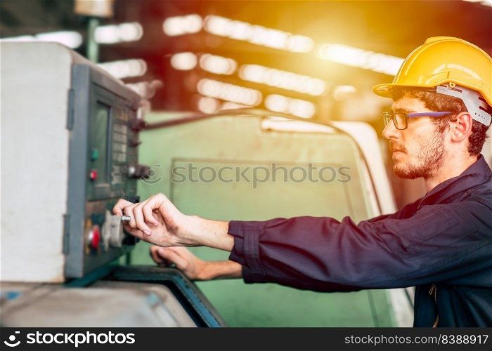Young professional technician engineer operate the machine to automated CNC in heavy industrial factory.