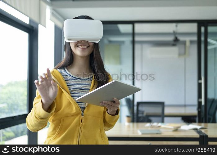 Young programmer or software developer with virtual reality glasses to testing 3D games and application. Technology and software development concept.