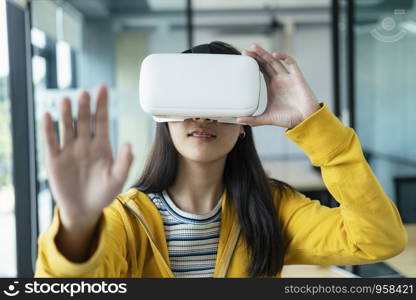 Young programmer or software developer with virtual reality glasses to testing 3D games and application. Technology and software development concept.