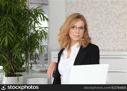 Young receptionist sitting at a desk