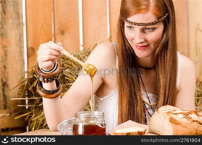 Young red-hair hippie woman organic breakfast in barn country style