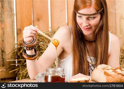 Young red-hair hippie woman organic breakfast in barn country style