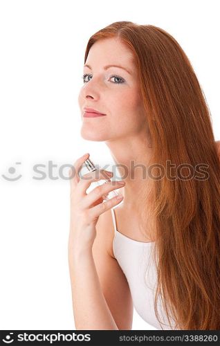 Young red hair woman applying perfume on white background