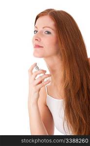 Young red hair woman applying perfume on white background