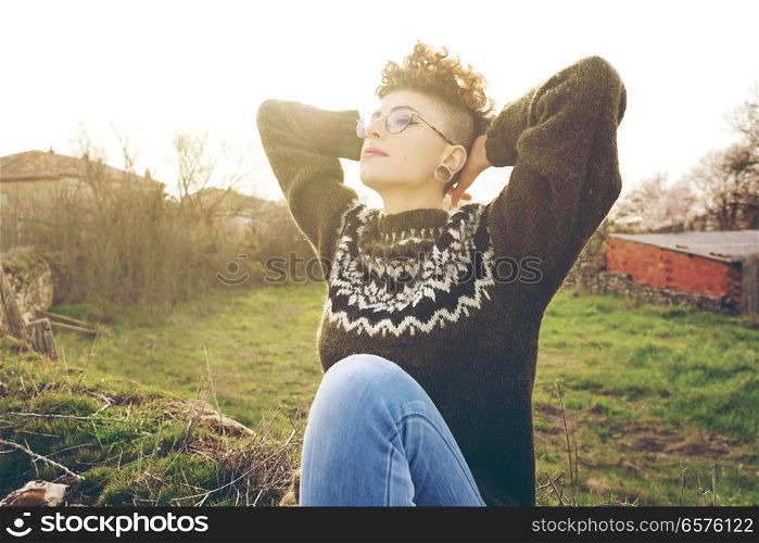 Young redhead woman enjoying the day in nature