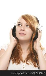 young redhead woman is daydreaming while listening to music with headphones. young redhead woman is daydreaming while listening to music with headphones on white background