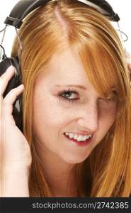 young redhead woman listening to music. young redhead woman listening to music on white background