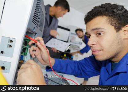young repairer working in computer service center