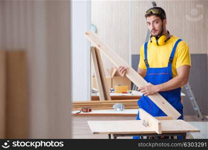 Young repairman carpenter working cutting wood