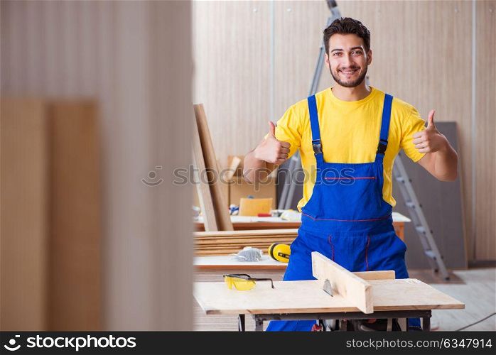 Young repairman carpenter working cutting wood