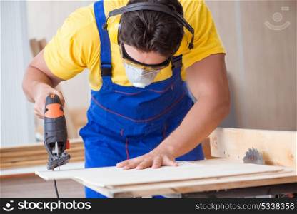 Young repairman carpenter working with a circular saw