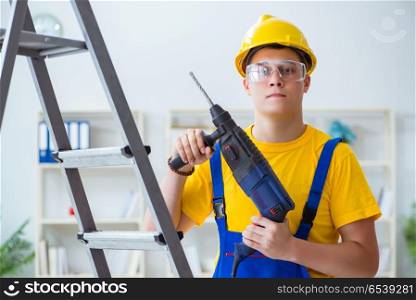 Young repairman with power drill